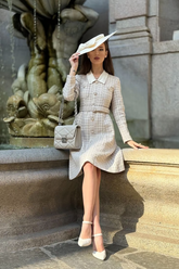 a lady in a tweed patchwork dress with a belt